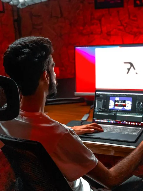 A modern computer screen displaying web design work, showcasing creative visuals in a workspace.